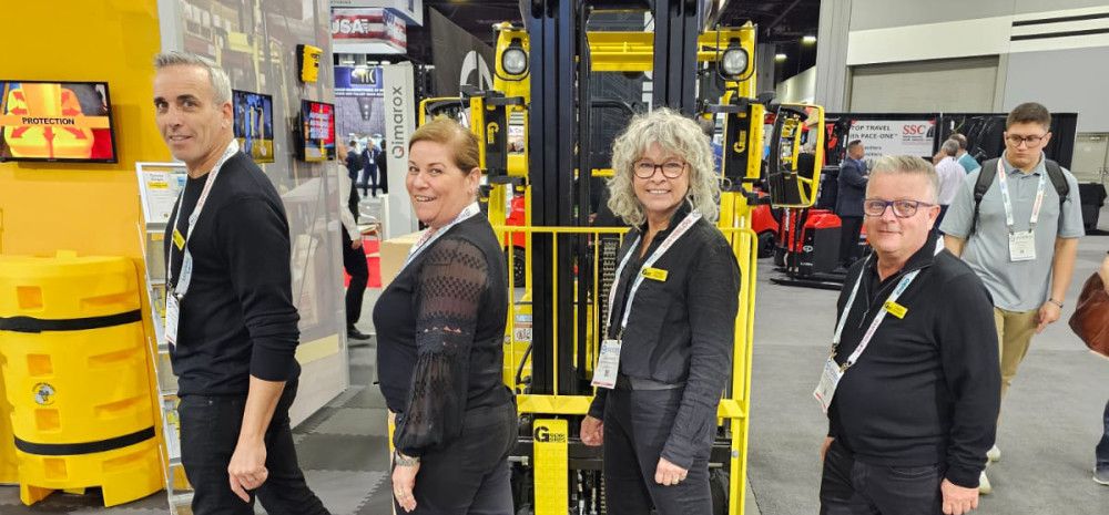 Four people smiling with equipment