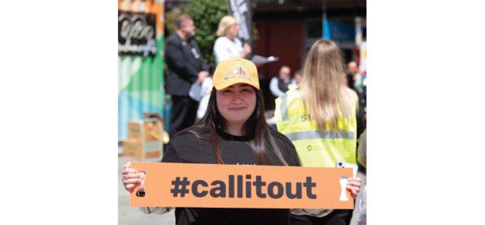 A lady holding a sign #callitout