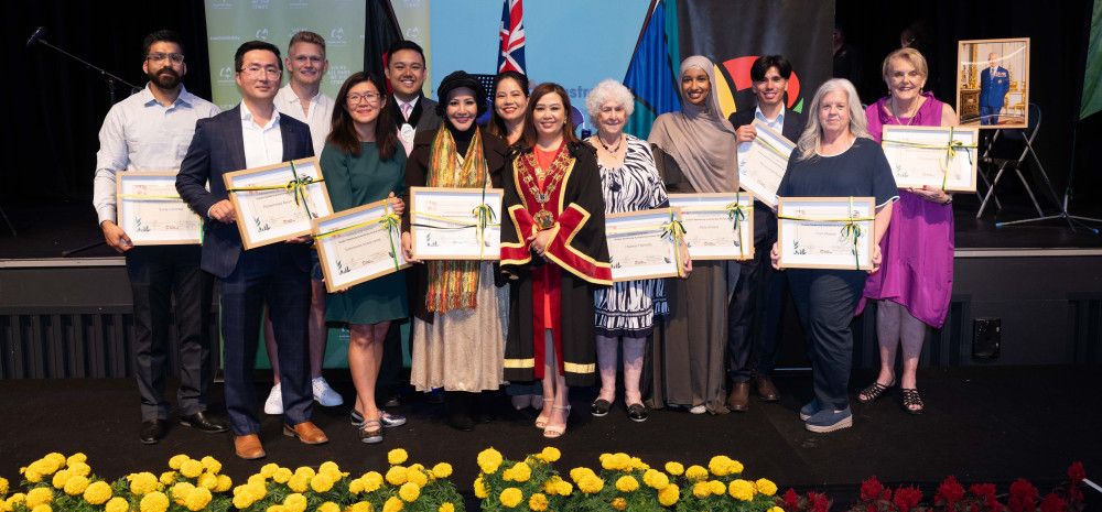 A large group of people all holding awards and smiling at the camera