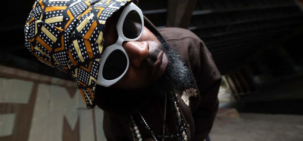 Mr. Congo posing for a photo in an alleyway 