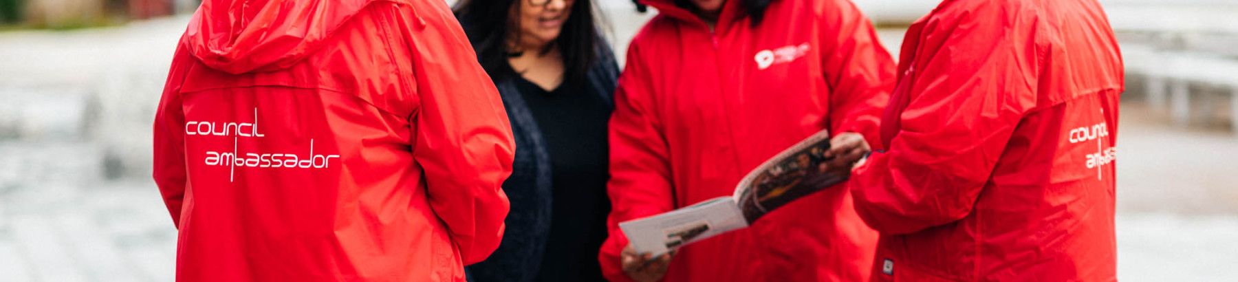 people in red jackets standing in a circle