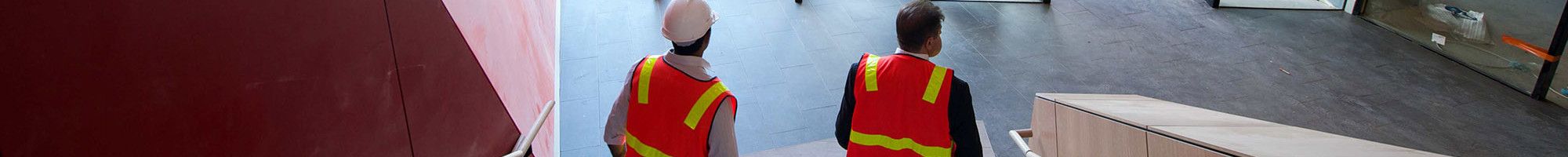 two men in hi vis on stairs