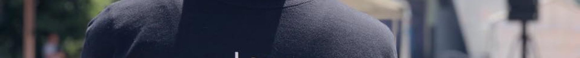 man with back to us with 'I say no to family violence' t-shirt on