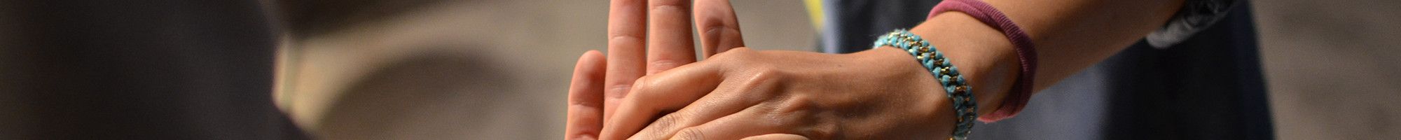 two people connecting via touching hands