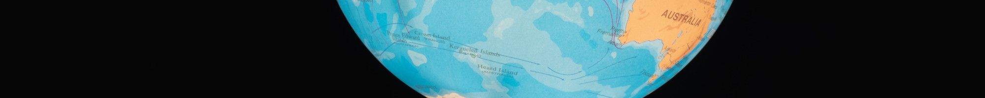 world globe floating above hand