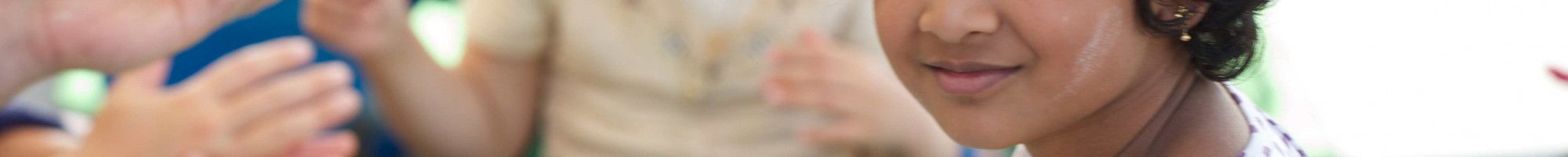 Young girl sits at a craft table