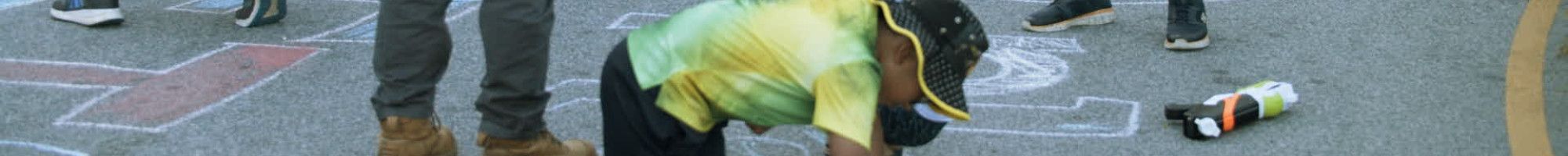 Children and parents drawing on a pavement
