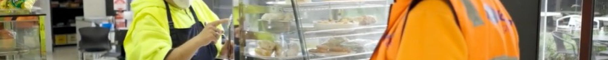 a person serving another person at a cafe counter