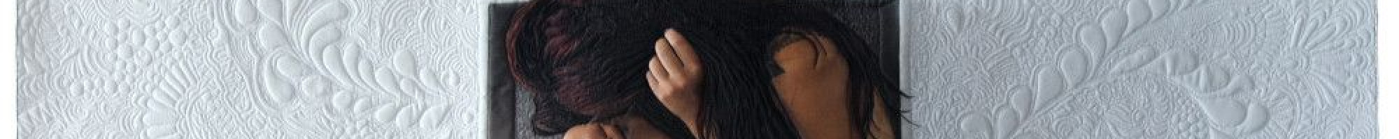 A woman crouched inside a hole in a white, textured wall.