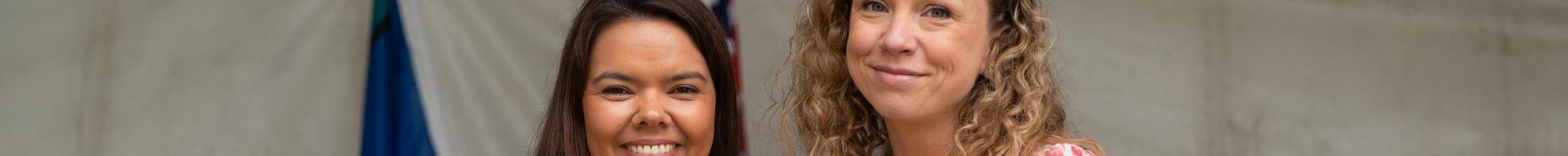 Mayor Eden Foster and Zoe Mohl holding a framed certificate