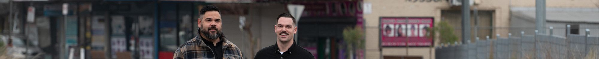Artists Robert Michael Young and Koby Sainty standing in the middle of a road