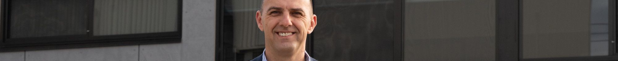 Councillor Bob Milkovic standing in front of the Rosewood Downs Primary School Kindergarten