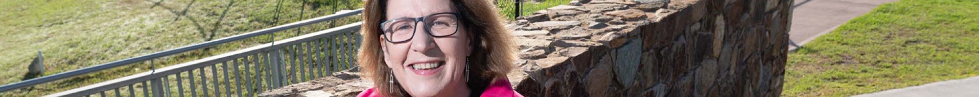 Councillor Rhonda Garad leaning against a brick wall