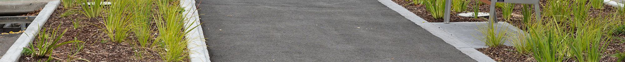 Image of a footpath and shops in the background