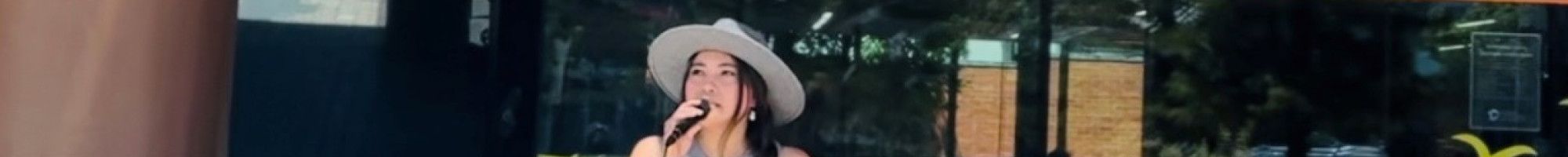 A person busking outside Dandenong Library.