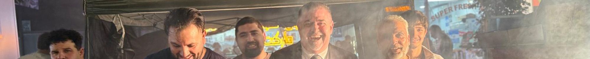 People enjoying cooking a barbecue.