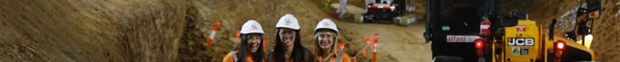 Three ladies standing in a construction site