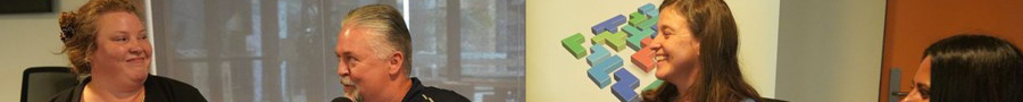 Four people sitting and talking