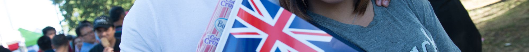 Two smiling people holding an Australian Flag