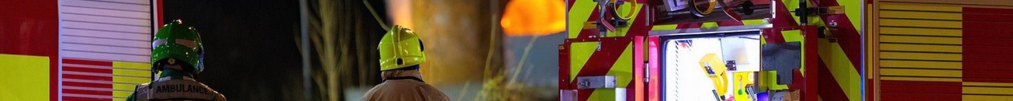 A fire truck and two emergency people