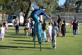 A performer engaging with children