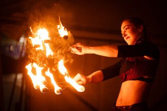 Fire twirler performance on stage 