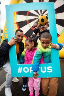 Family posing with sponsor Optus photo frame