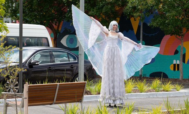 A performer with wings in her outfit