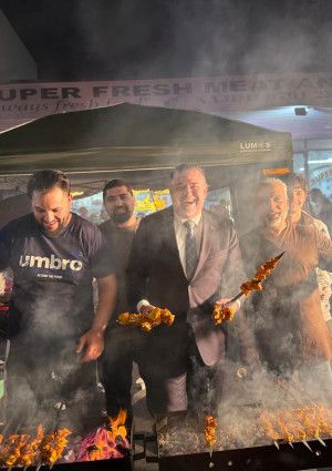 People enjoying cooking a barbecue.