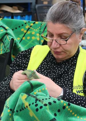 A women sewing at Sisterworks
